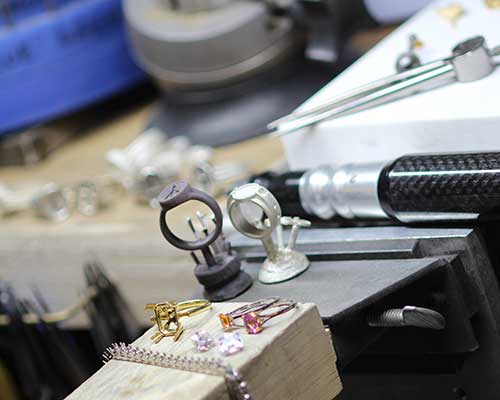 A jewelry bench pin with tools at The Robert Christopher Company